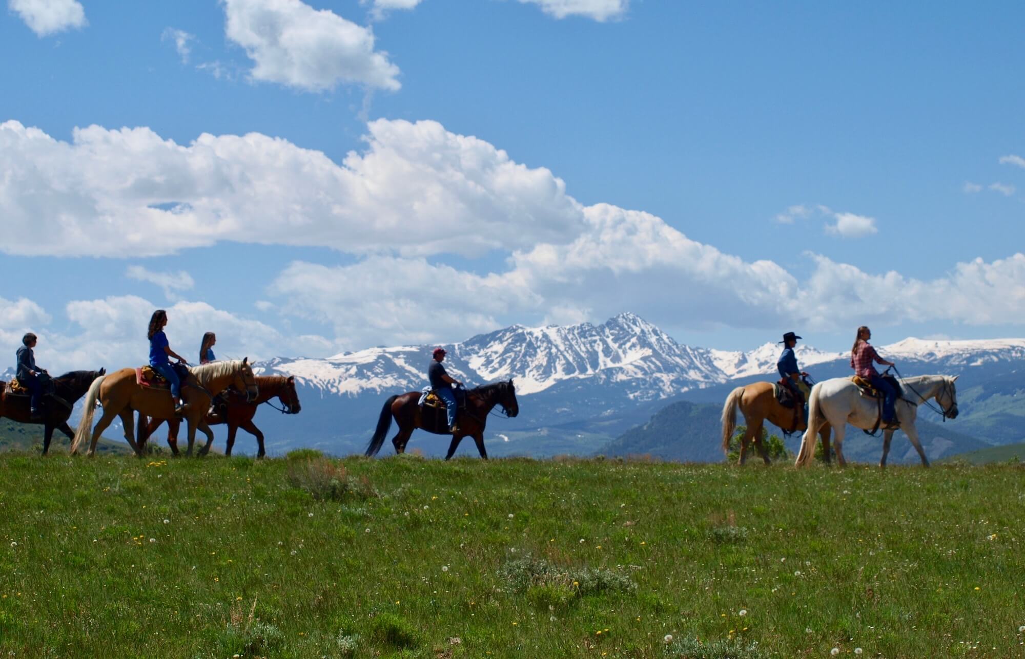 Beginner trail rider family enjoying gentle Colorado horseback riding with guided support at Rusty Spurr Ranch in Kremmling, Colorado.