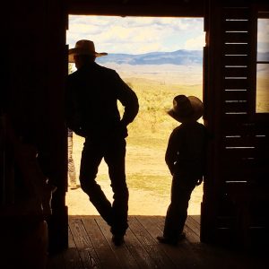 Family enjoying an authentic ranch experience with horses and mountain views at Rusty Spurr Ranch in Colorado.