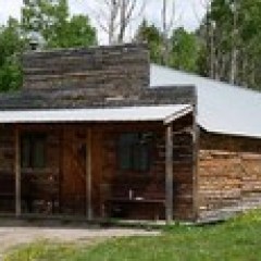a large brick building with grass in front of a house