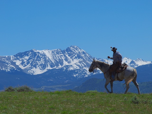 A serene view from atop a hill showcasing the vast expanse of Rusty Spurr Ranch's off-trail routes