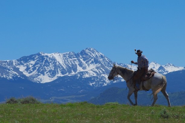 A serene view from atop a hill showcasing the vast expanse of Rusty Spurr Ranch's off-trail routes
