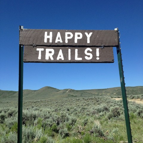 A rustic sign adds charm and humor to the entrance of the ranch, creating a fun atmosphere as soon as guests arrive.