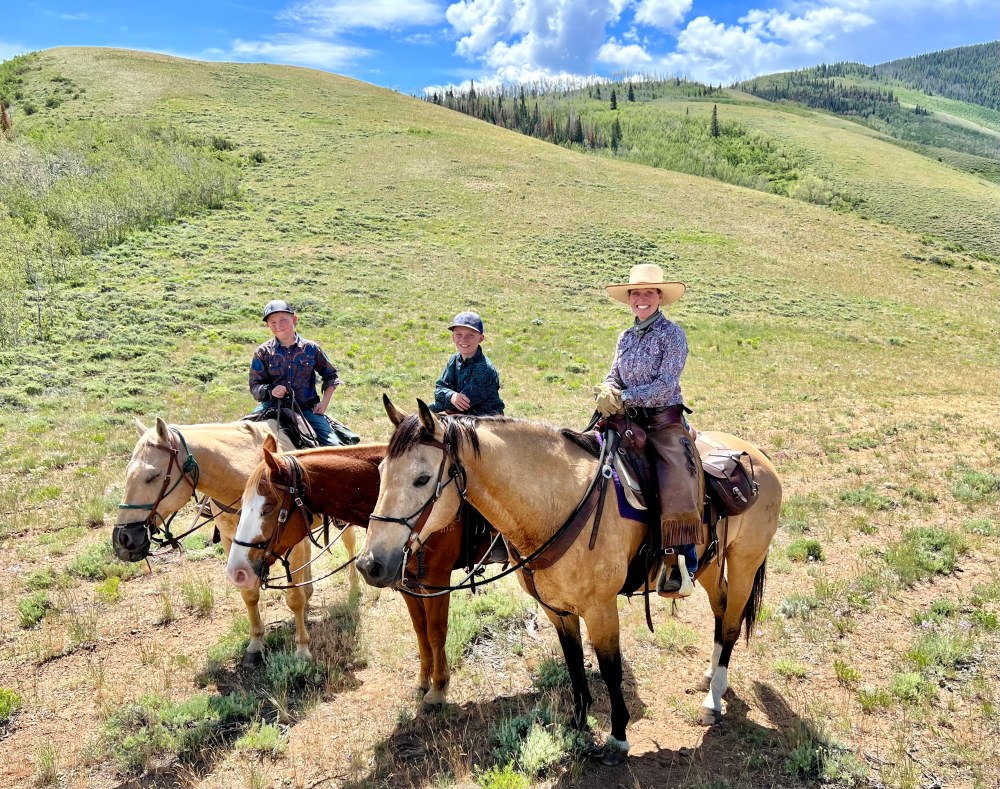 Parent and kids on horseback exploring trails at Rusty Spurr Ranch